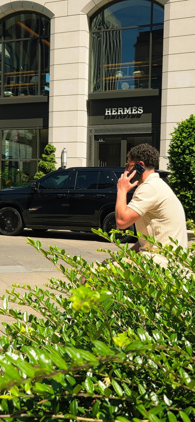 Joshua Daniels on a call outside Hermès
